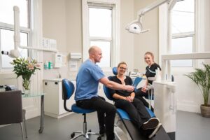 Sinus lift surgery Charlottesville dental patient looking at her smile https://pixabay.com/photos/all-on-4-dental-implants-belfast-8378579/ 