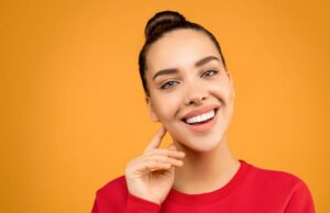 Photo by Sound On: https://www.pexels.com/photo/photo-of-woman-wearing-red-top-3760737/ - woman smiling with restored smile