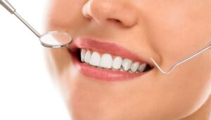 https://pixabay.com/photos/caries-checkup-clinic-clinical-10184704/ Woman smiling at dentist office.