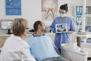 https://www.magnific.com/free-photo/stomatologist-nurse-with-face-mask-holding-tabet-computer-explaining-teeth-radiography-sick-patient-dentistry-consultation-stomatological-office-room-team-working-caries-treatment_24816237.htm#fromView=keyword&page=2&position=3&uuid=c0791526-6273-4eb4-9464-6ceb2f2cac15&query=Dental+learning Dentist describing wisdom teeth removal.